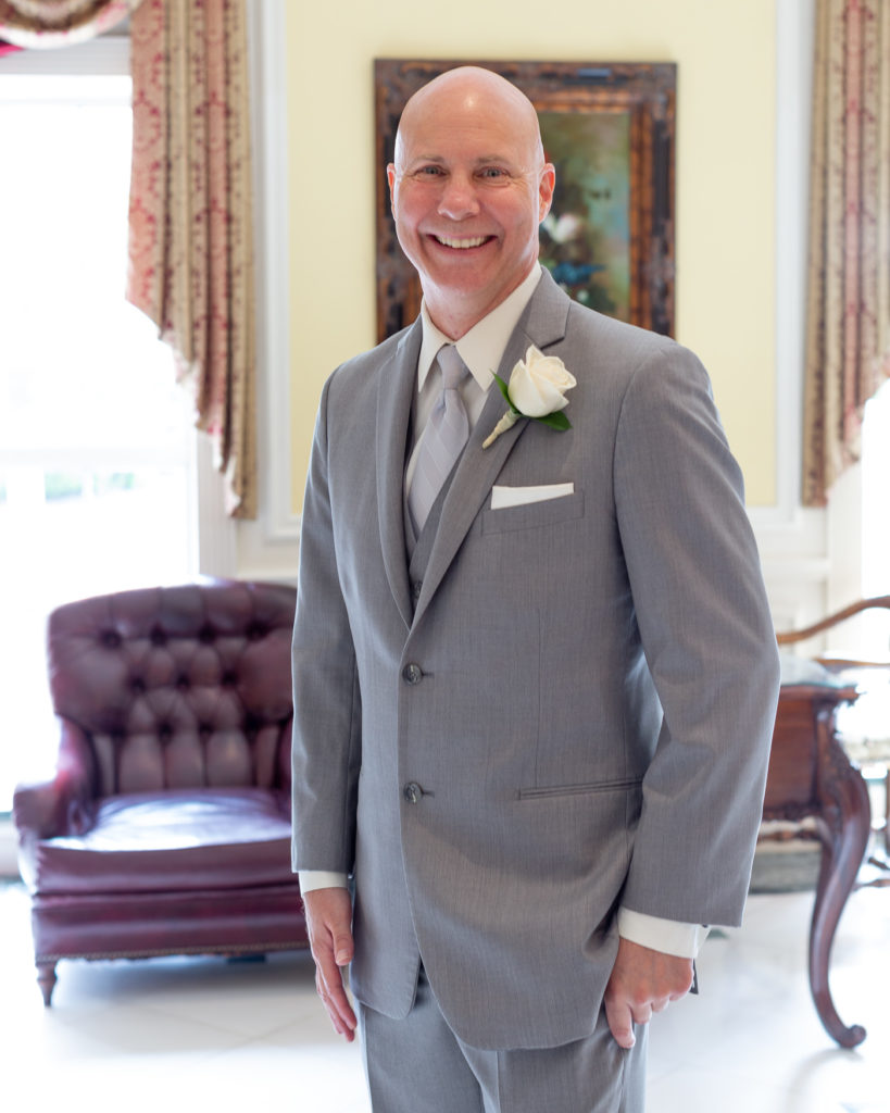 Elegant groom portrait in the lobby at Molly Pitcher Inn in Red Bank, NJ photographed by Laura Billingham Photography