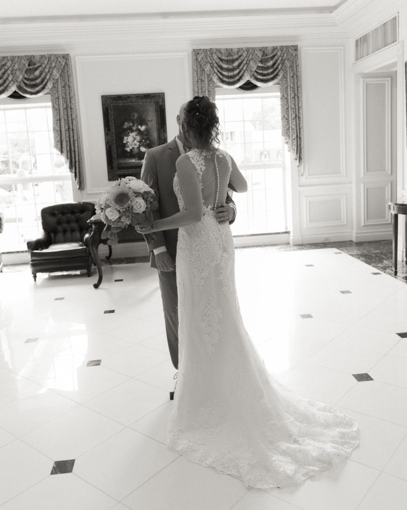 Bride and groom enjoy a first look in the lobby of the Molly Pitcher Inn in Red Bank, NJ photographed by Laura Billingham