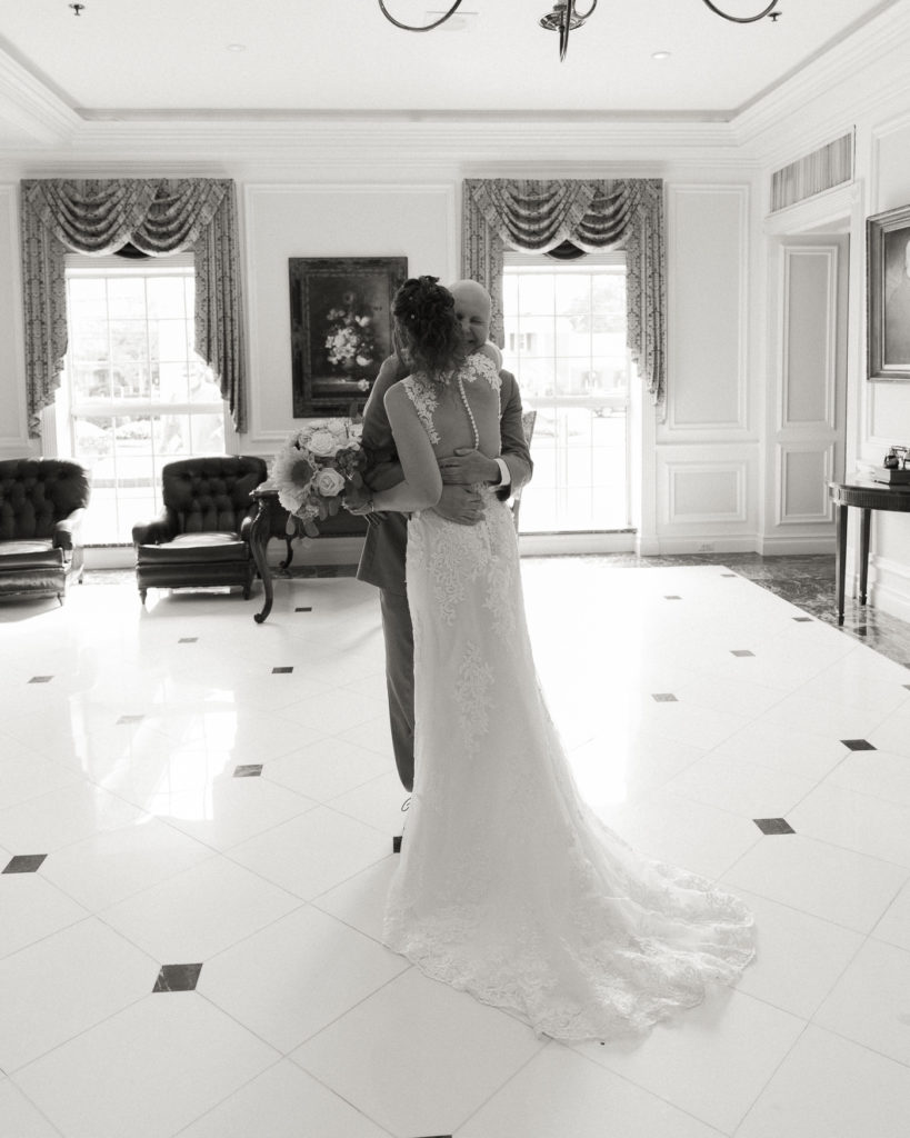 Bride and groom enjoy a first look in the lobby of the Molly Pitcher Inn in Red Bank, NJ photographed by Laura Billingham