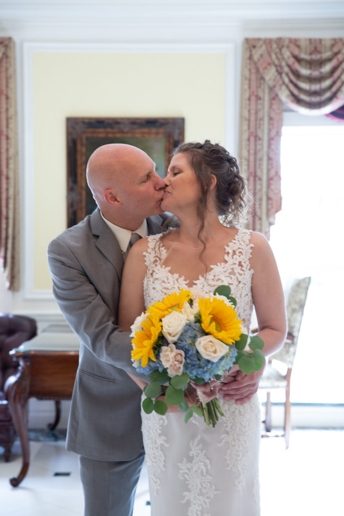 Bride and groom enjoy a first look in the lobby of the Molly Pitcher Inn in Red Bank, NJ photographed by Laura Billingham