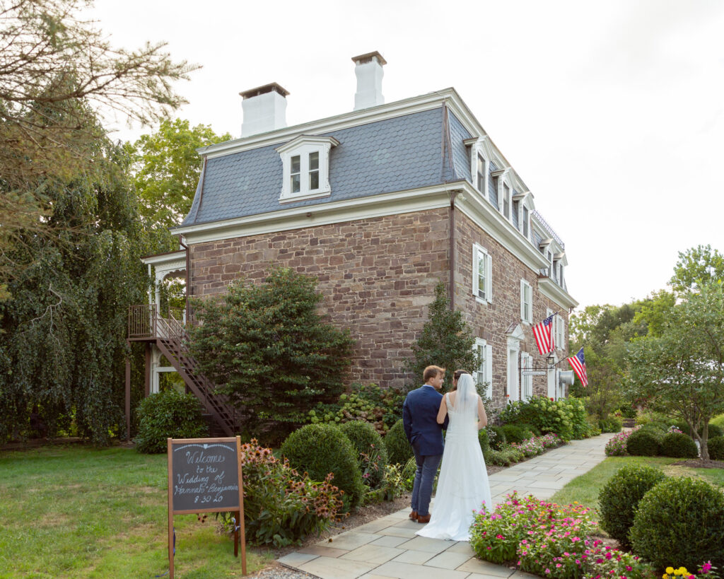 bride and groom enjoy a walk at the Woolverton Inn in Stockton, NJ wedding photography by Laura Billingham