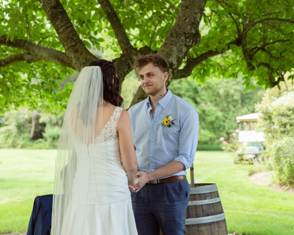 elegant bride and groom say vows at their rustic wedding ceremony. Woolverton Inn wedding photography by Laura Billingham