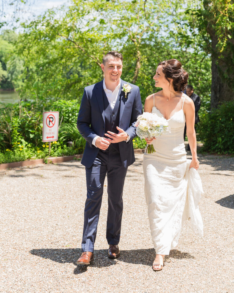 An elegant bride and groom walking after their wedding ceremony by Bridgeton House on the Delaware photographed by Laura Billingham Photography