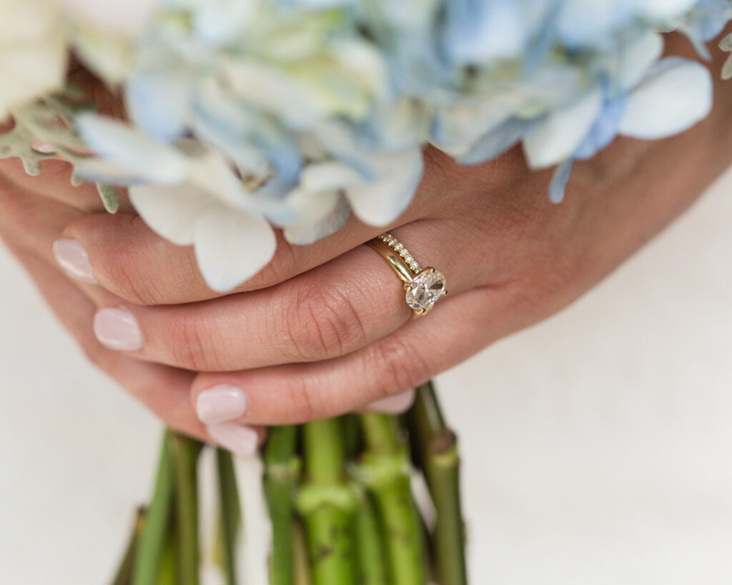 Detail of an elegant summer bridal bouquet and bride's hands with wedding rings at Bridgeton House on the Delaware by Laura Billingham Photography