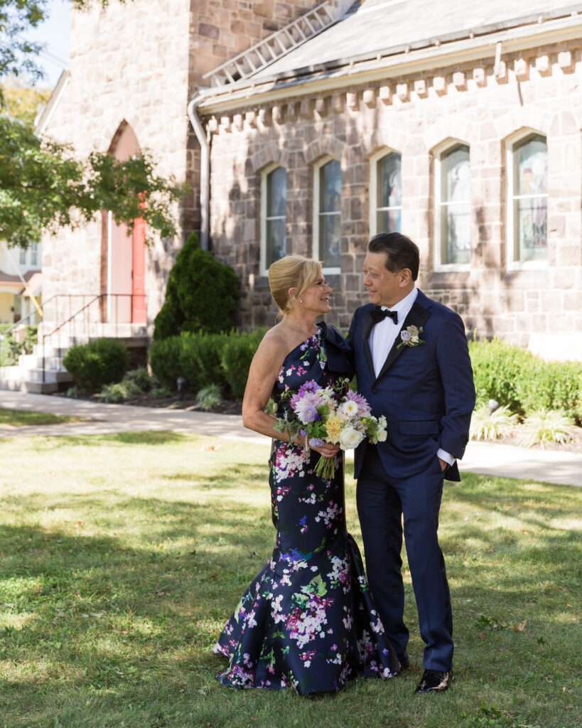 Full length portrait of an elegant bride  and groom after their wedding ceremony at Flemington Presbyterian Church in Flemington, NJ by Laura Billingham Photography