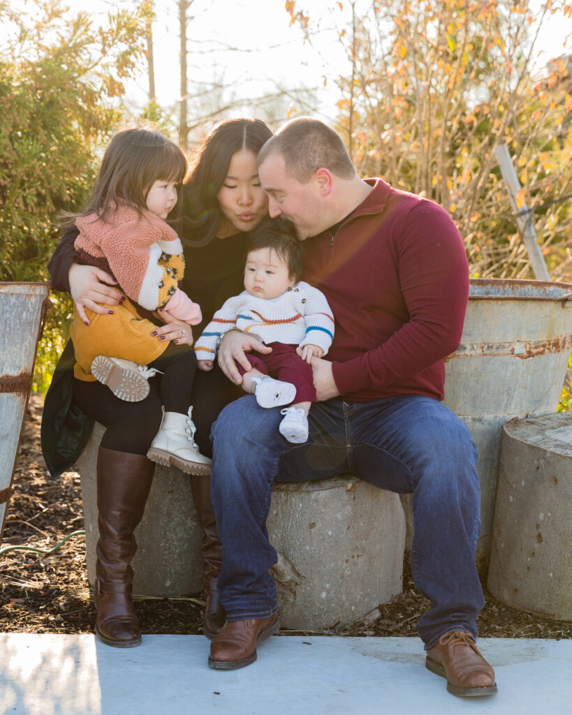 A family snuggles for a portrait during a mini session at Black Shed in Stockton, NJ photographed by Laura Billingham
