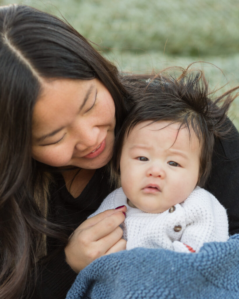 An Asian mom snuggles with her baby boy at a mini portrait session at Black Shed in Stockton, NJ photographed by Laura Billingham
