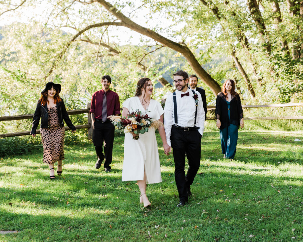 Wedding party walks in Sunbeam Park after bride and groom's micro wedding ceremony at 15 Landsdowne in Frenchtown, NJ photographed by Laura Billingham