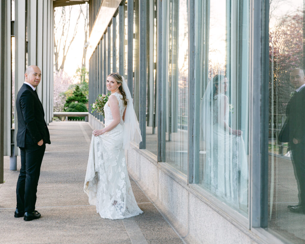 Elegant bride and groom look back over the shoulders at sunset at the Bethlehem Area Public Library