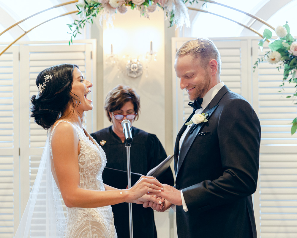 Bride laughs during wedding ceremony at the Bernards Inn in Bernardsville, NJ