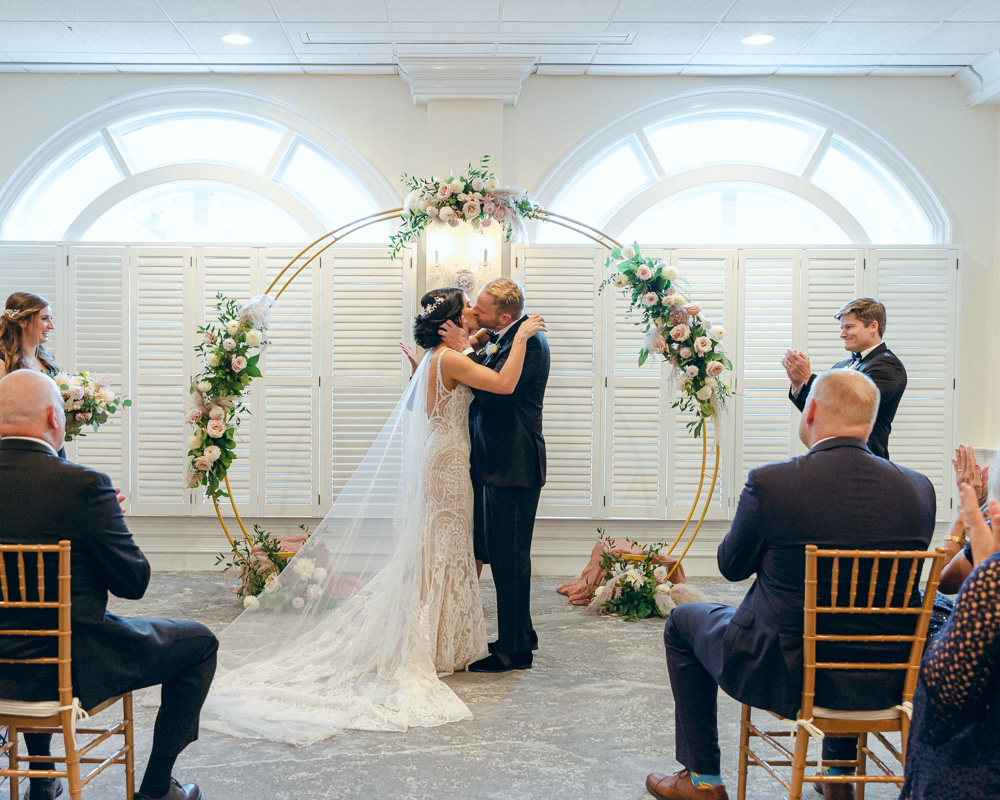 Elegant bride and groom kiss at their wedding ceremony at the Bernards Inn in Bernardsville, NJ