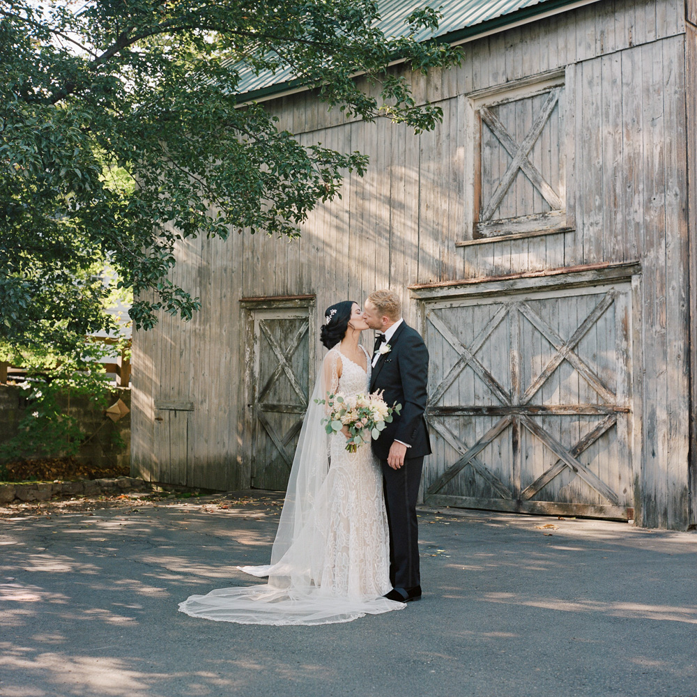 Elegant bride and groom kiss at the Bernards Inn in Bernardsville NJ by film photographer Laura Billingham Photography