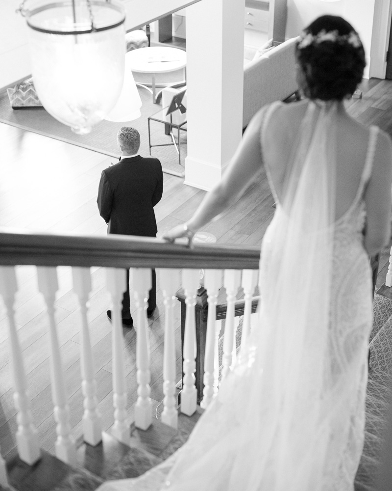 Elegant bride descends stairs to waiting groom at the Bernards Inn in Bernardsville, NJ