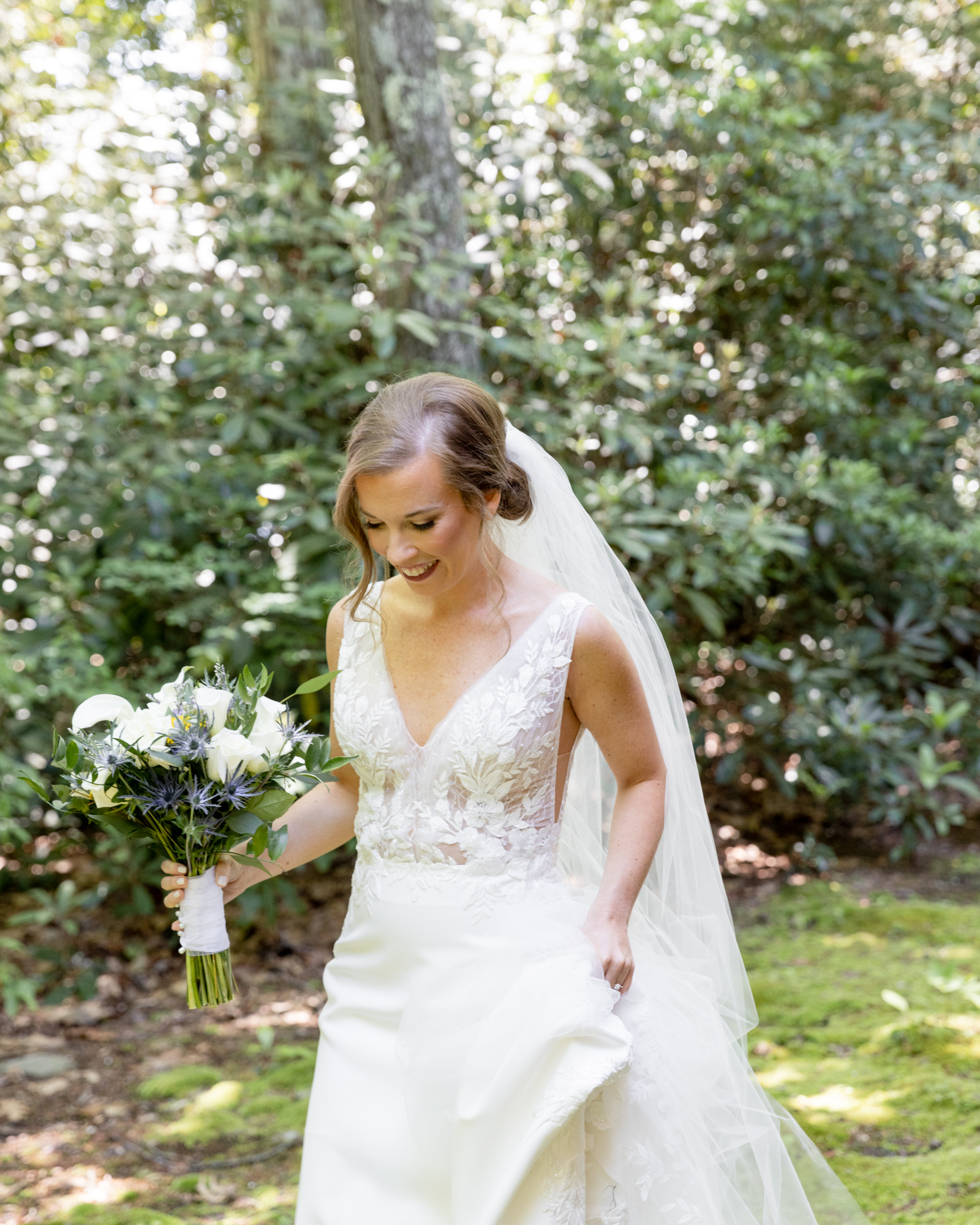 Elegant bride walks toward camera at The Lodge at Mountain Springs Lake in Reeders, PA
