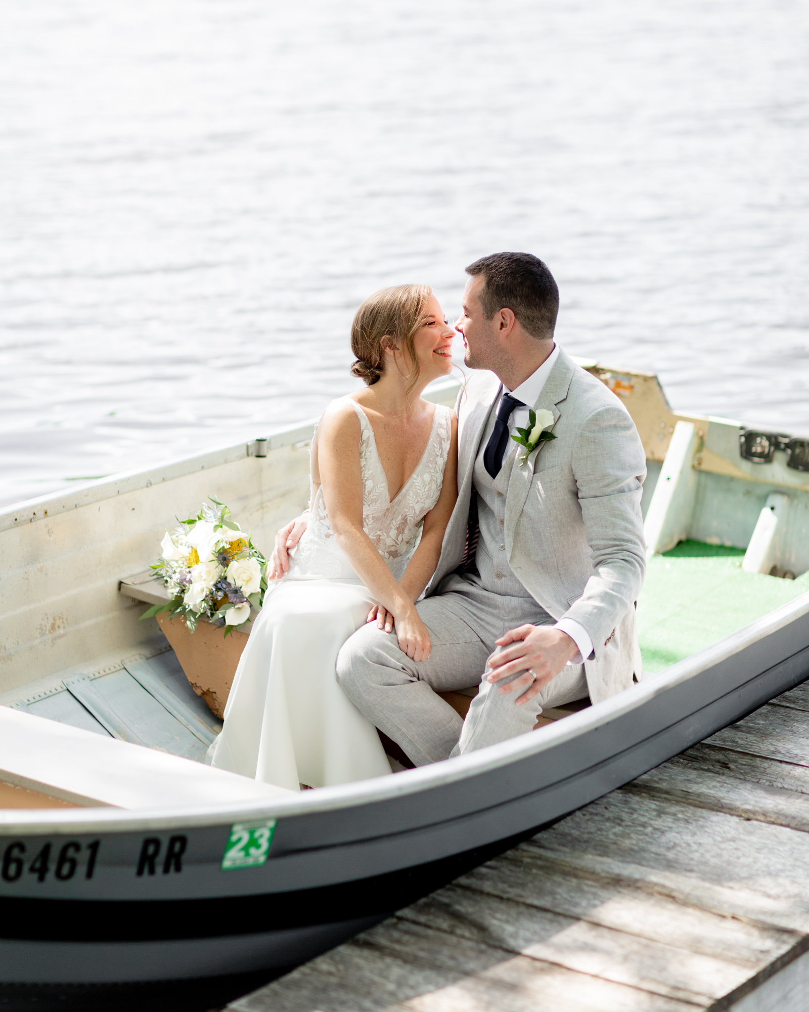 Elegant wedding couple in a rowboat at Mountain Springs Lake Resort in Reeders, PA