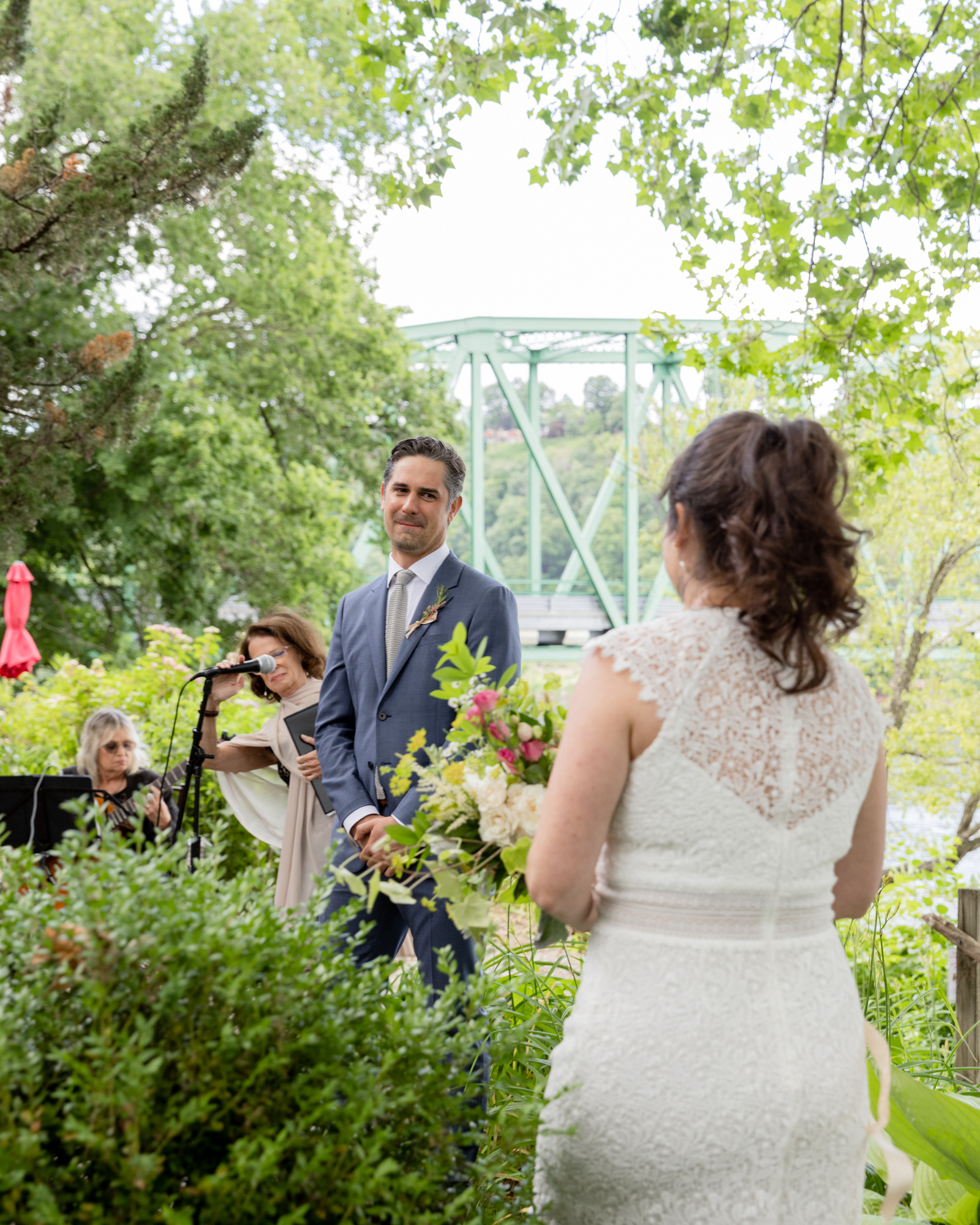 groom sees bride walking down the aisle at wedding ceremony at Bridgeton House on the Delaware in Bucks County, Pa