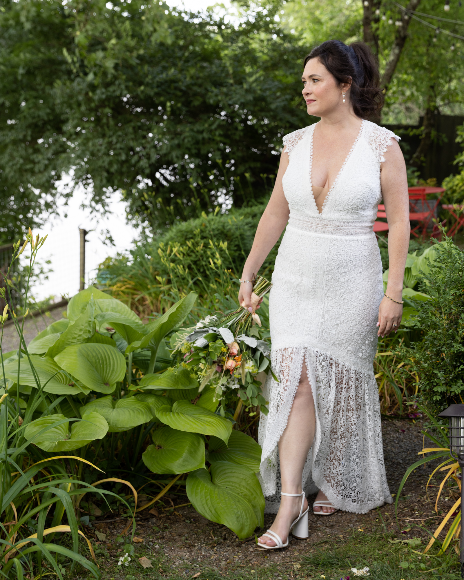 Candid photograph of an elegant bride walking after her wedding at Bridgeton House on the Delaware in Bucks County, PA