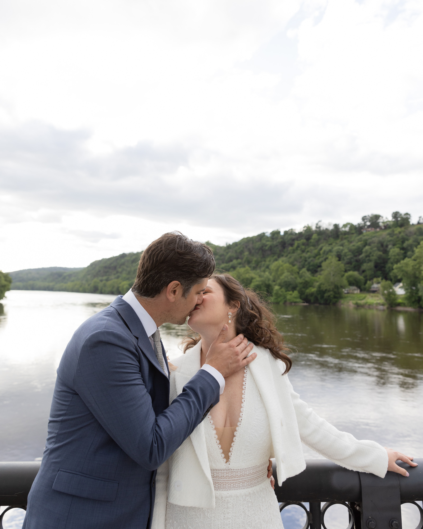 Elegant bride and groom share a romantic kiss on the Milford Bridge in Bucks County, PA