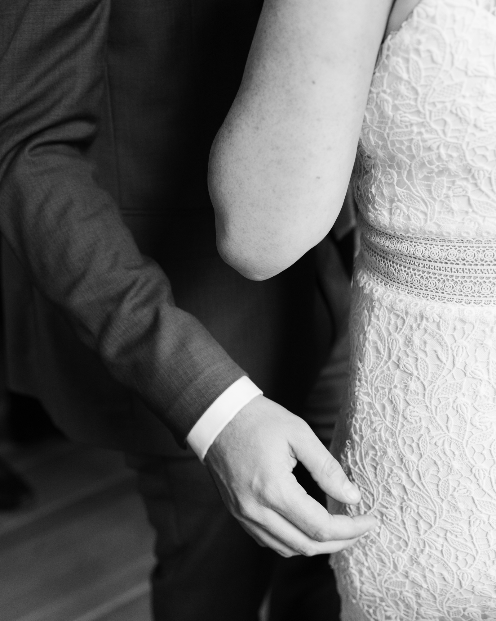 Detail of a an elegant bride and groom embracing at their wedding reception at Canal House Station in Milford NJ