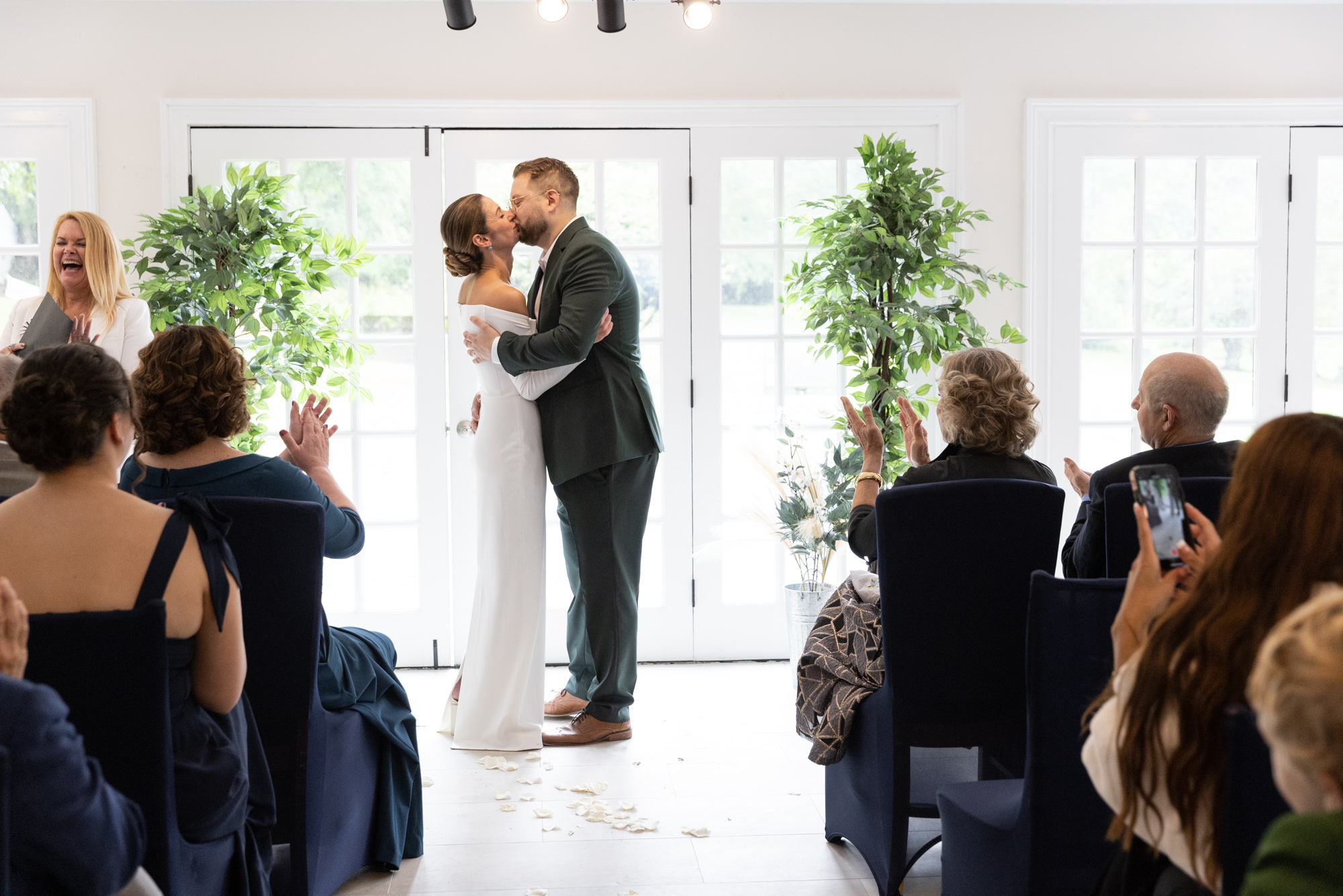 A bride and groom kiss during their modern elegant wedding ceremony at Chimney Hill Estate Inn in Lambertville, NJ