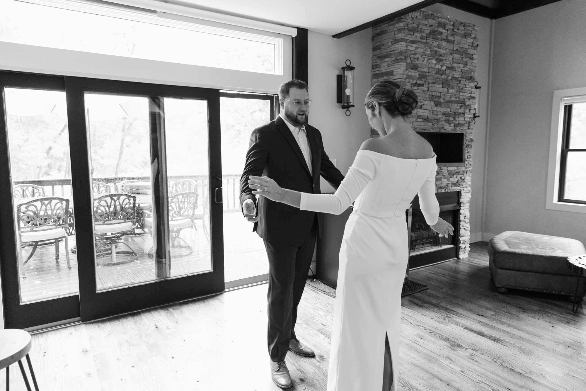 Black and white photo of an elegant bride greeting the groom during their first look at their wedding at Chimney Hill Inn Estate in Lambertville, NJ