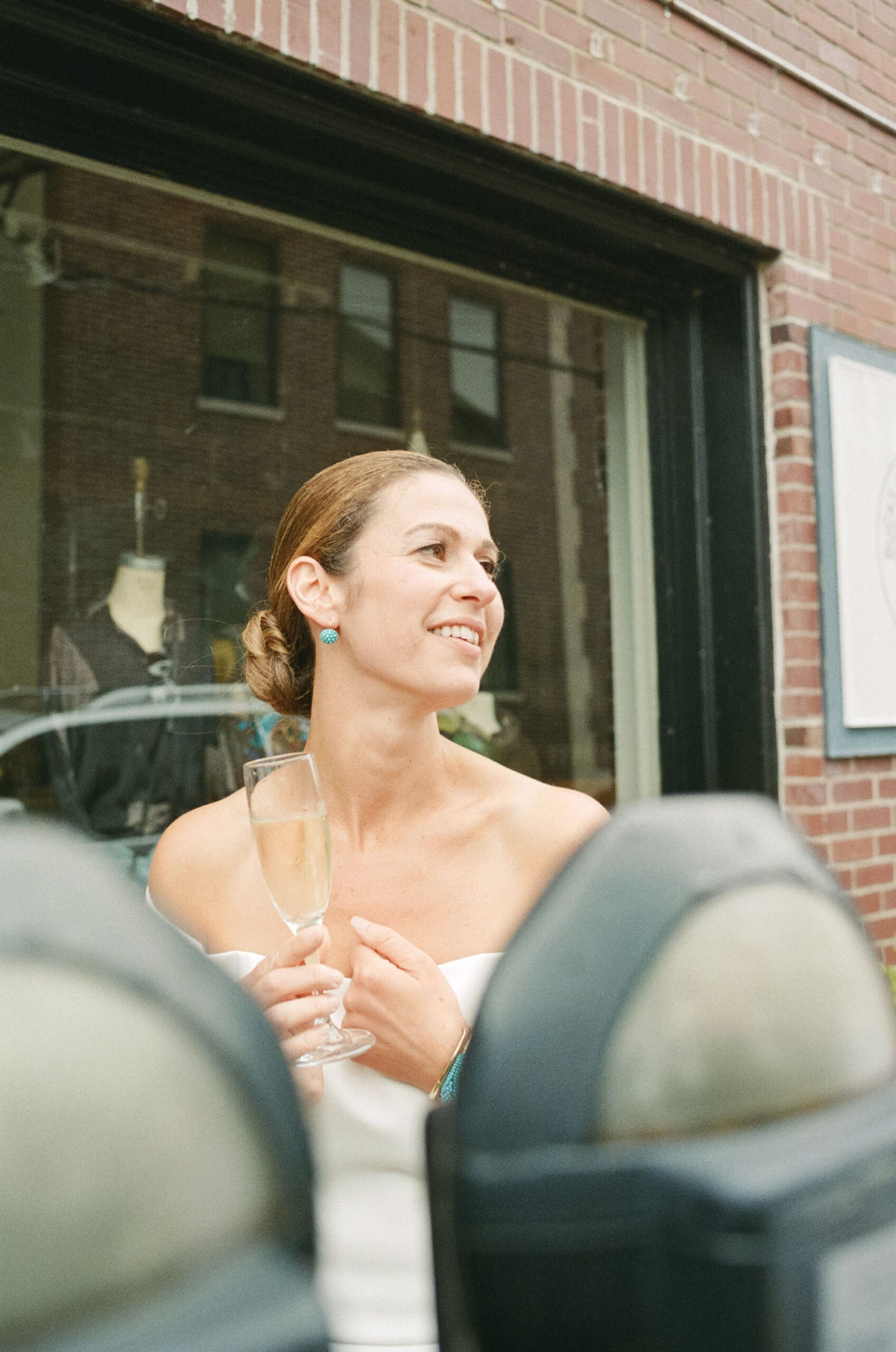 Color candid photo of an elegant bride near parking meters outside her intimate wedding reception at Brian's restaurant in Lambertville, NJ