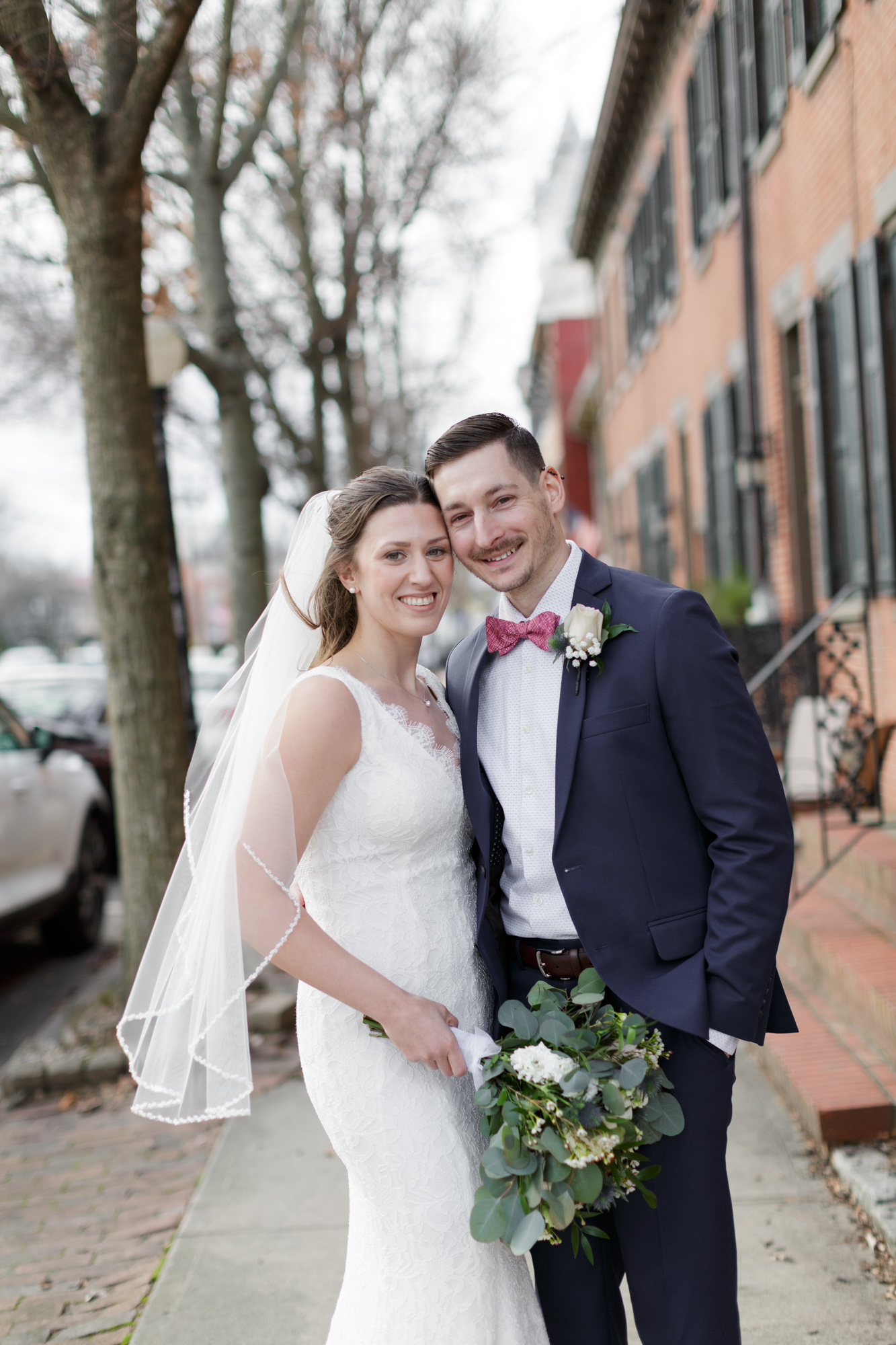 Elegant bride and groom pose for a portrait after their wedding at Old City Hall in Bordentown, NJ