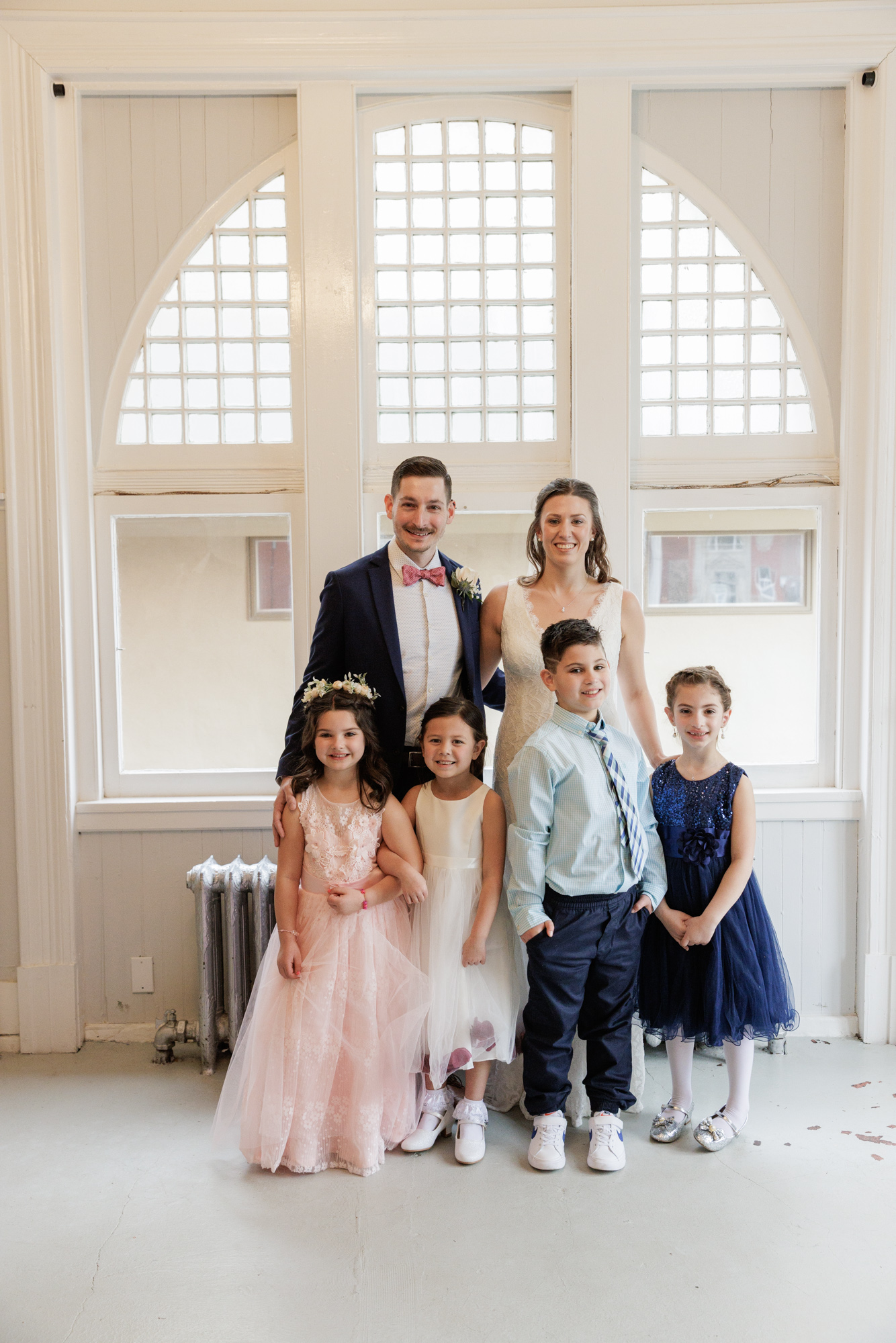 Bride and groom pose with four children from their wedding party after their wedding ceremony at Old City Hall in Bordentown, NJ