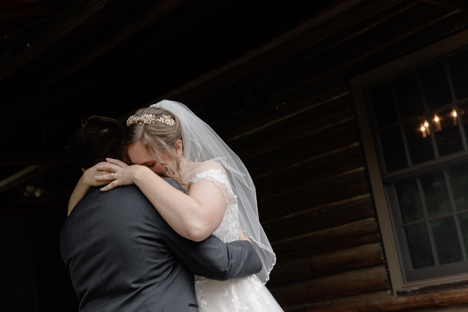 A bride and groom have a tearful embrace at their wedding at Rutgers Gardens and Suydam Farms