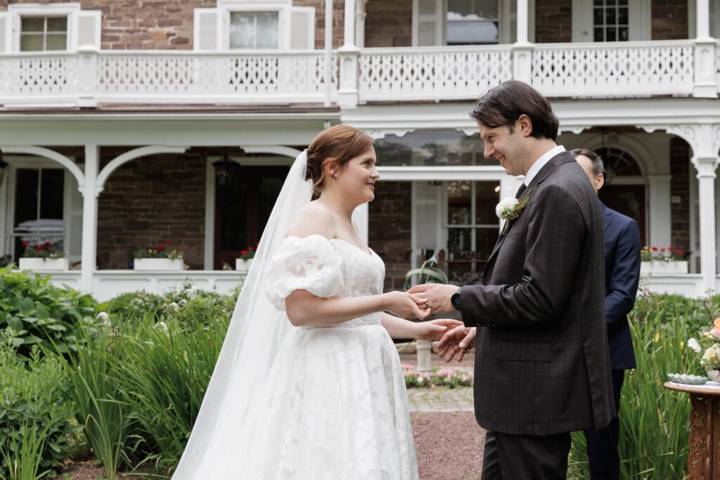 A couple in formal wedding attire say their vows at the Woolverton Inn
