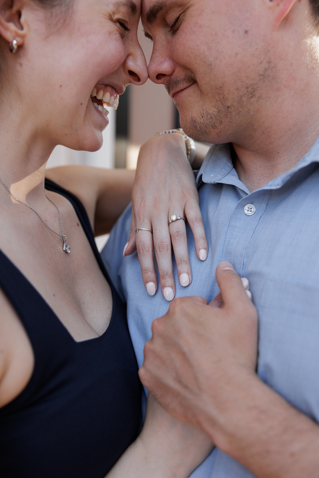 Couple embraces on Bridge Street, Phoenixville where they had their first date, during engagement session photography
