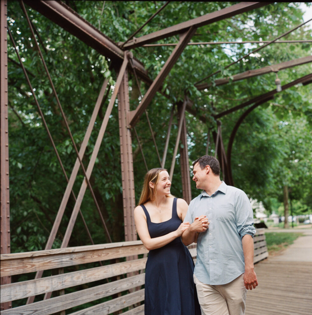 Bride-to-be Selah smiles naturally at Brendan during engagement session photographer shoot in Phoenixville