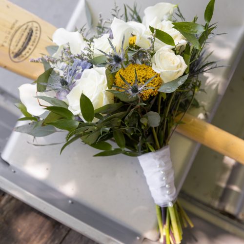 elegant wedding bouquet on a paddle in a rowboat at the Lodge at Mountain Springs Lake Resort in Reeders, PA